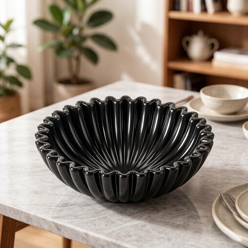 Black fluted resin centerpiece bowl styled on light wood table