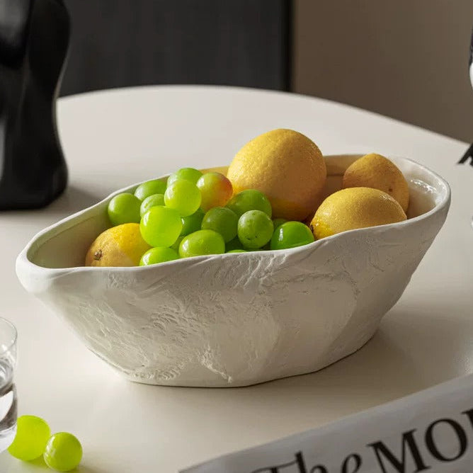 White textured ceramic centerpiece bowl filled with green grapes and citrus