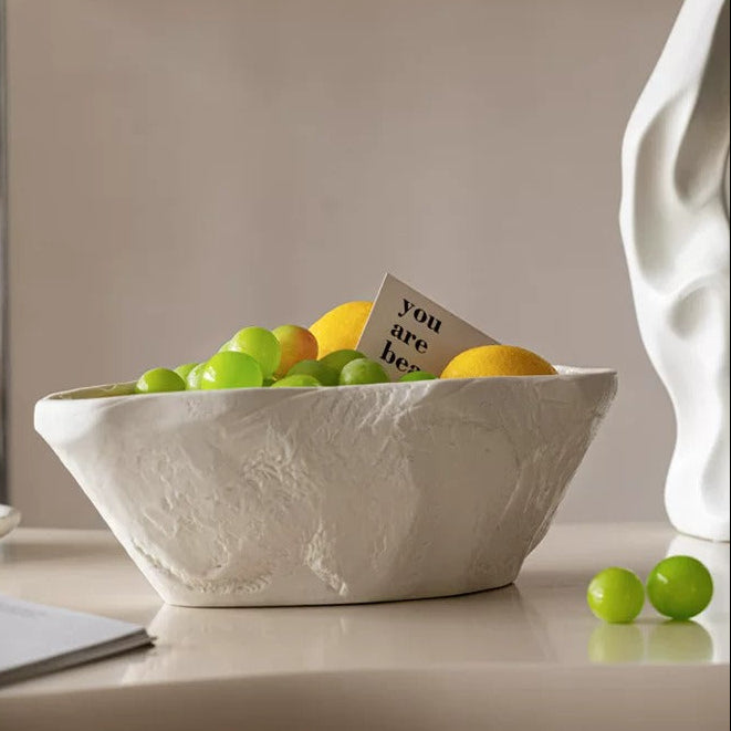White sculptural ceramic centerpiece bowl styled with fruit on modern tabletop
