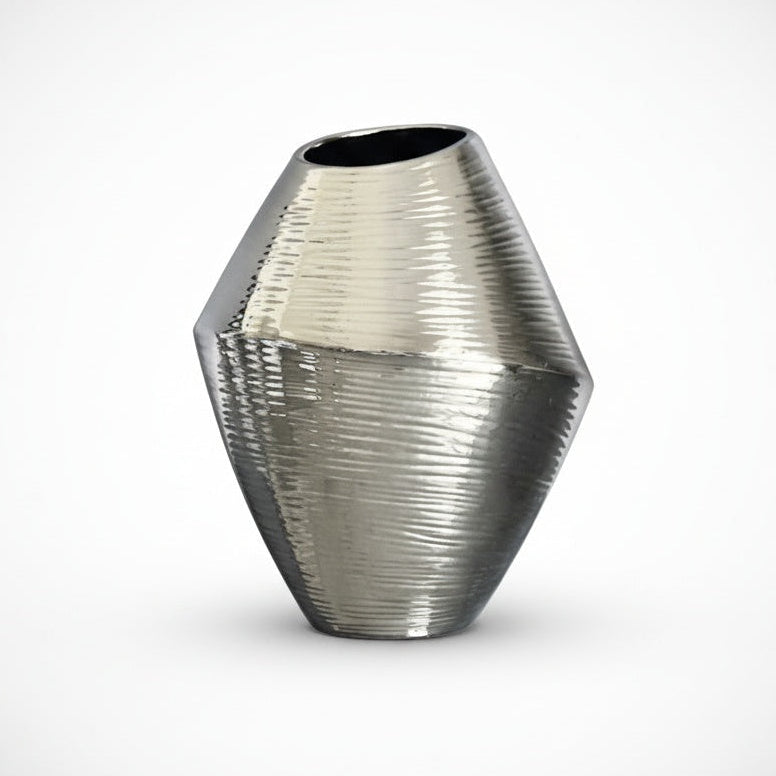 Chubby silver ceramic vase with reflective textured metallic finish on white background