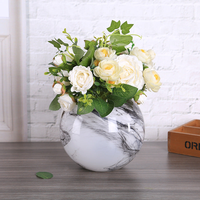 Smoky black and white marble glass vase styled with white flowers on a tabletop