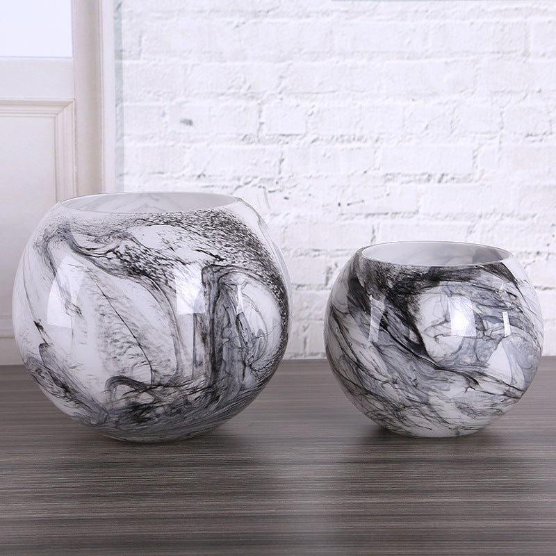Black and white marble glass vases in large and medium sizes on a wooden surface