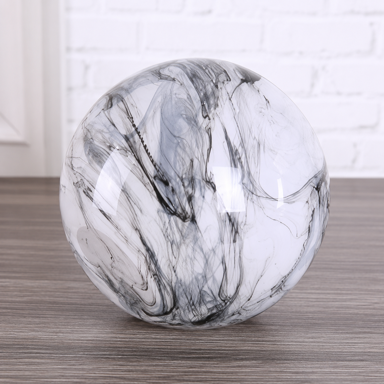 Base part of a smoky black and white marble glass vase on a tabletop