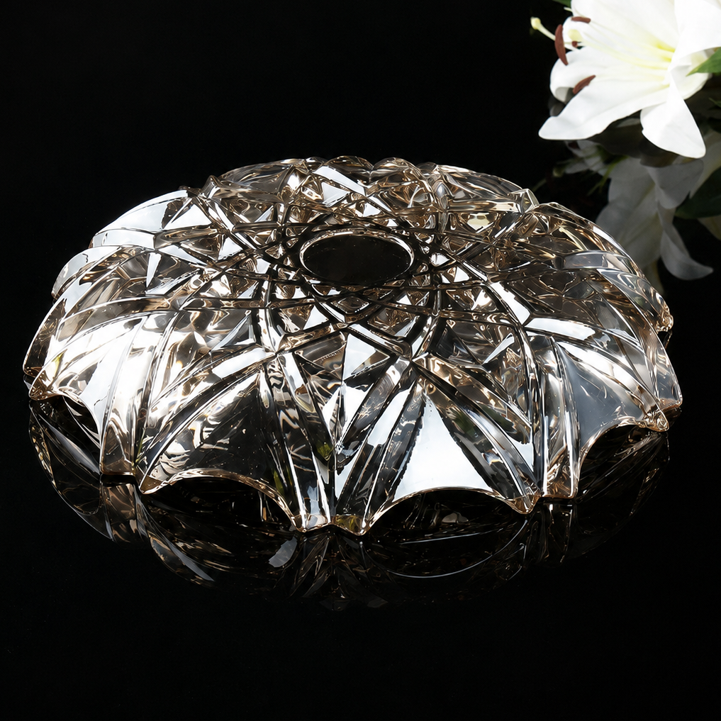 Underside of smoky faceted glass bowl showing geometric cut glass details