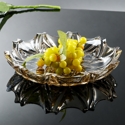 Smoky faceted glass centerpiece bowl with green grapes on reflective black table