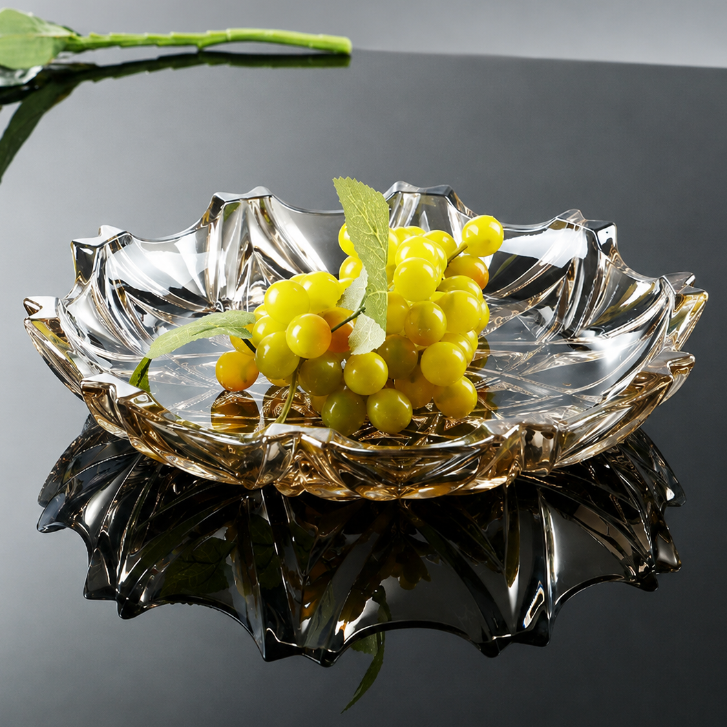 Smoky faceted glass centerpiece bowl with green grapes on reflective black table