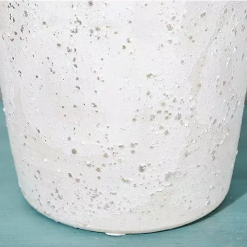 Close up of textured speckled white ceramic glaze on decorative vase