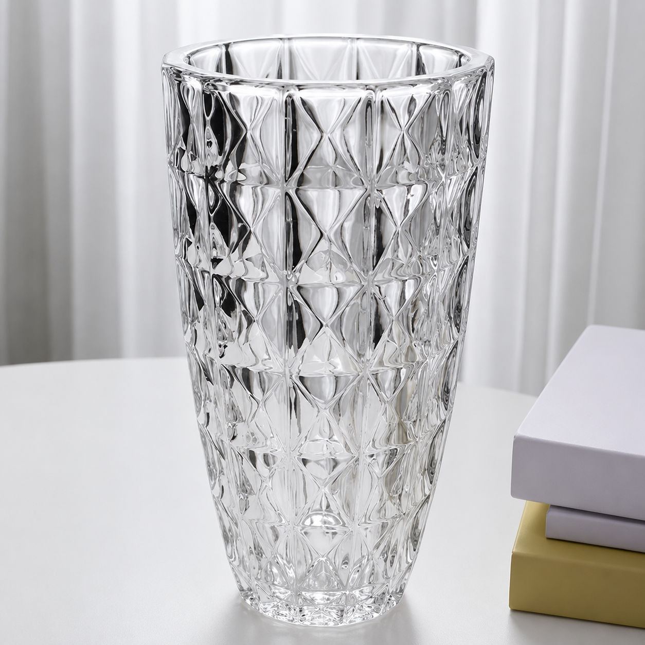 Clear diamond textured glass flower vase displayed beside stacked books