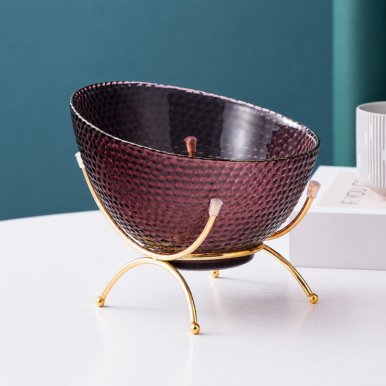 Maroon textured glass fruit bowl with gold rim and gold metal stand