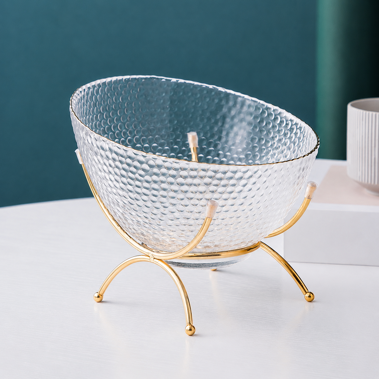 Clear textured glass fruit bowl with gold rim and gold metal stand