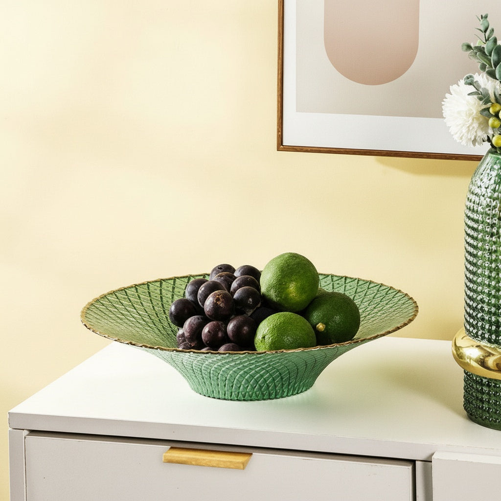 Green flared textured glass centerpiece bowl with grapes displayed on modern console