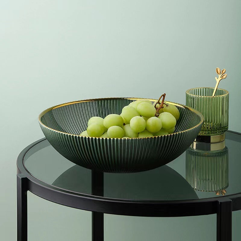 Green round textured glass fruit bowl displayed on black side table