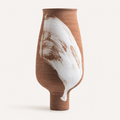 Tall textured terracotta ceramic vase with white brushstroke accent on white background