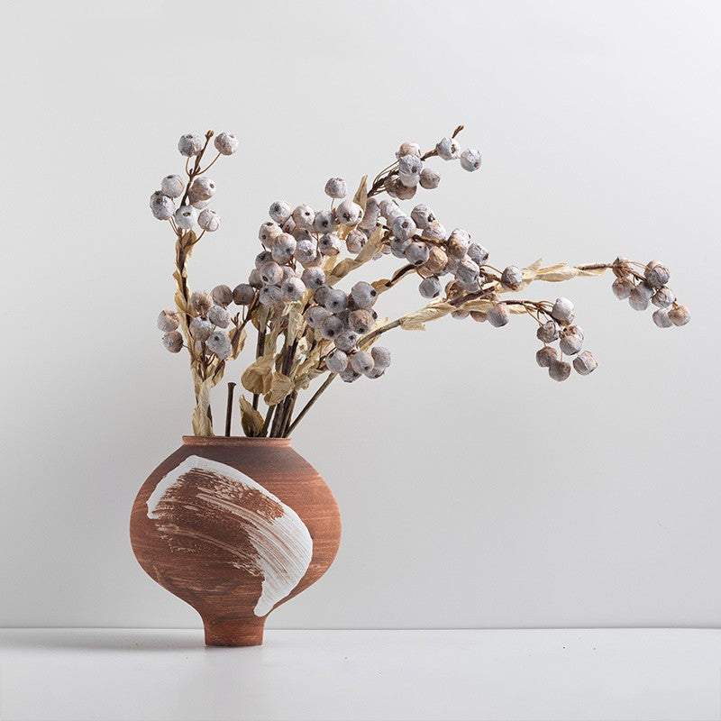 Short terracotta ceramic vase with white brushstroke detail styled with dried botanicals
