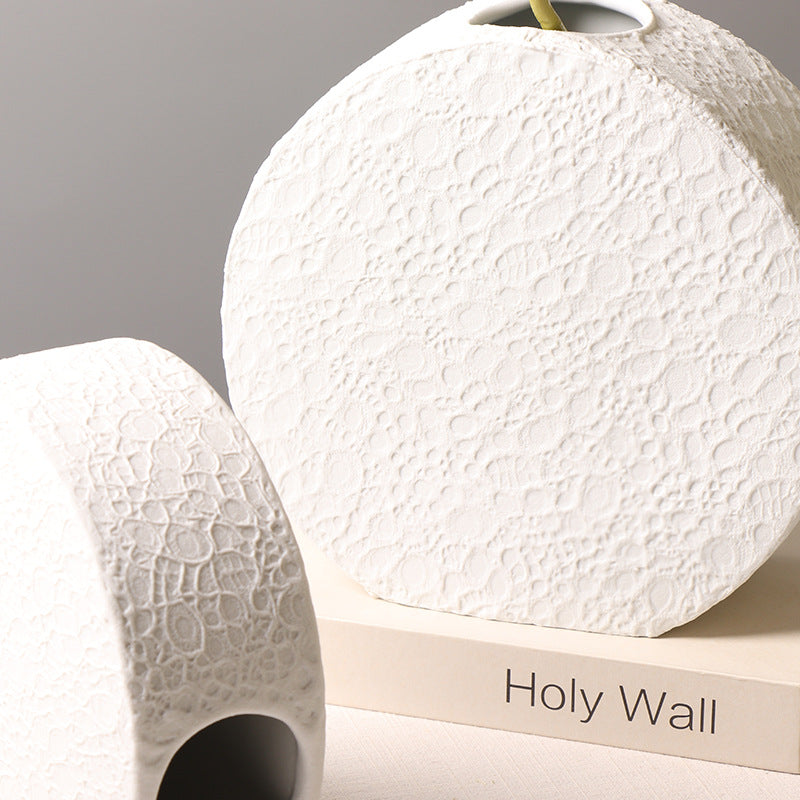 Close-up of textured white ceramic round vase surface and side profile
