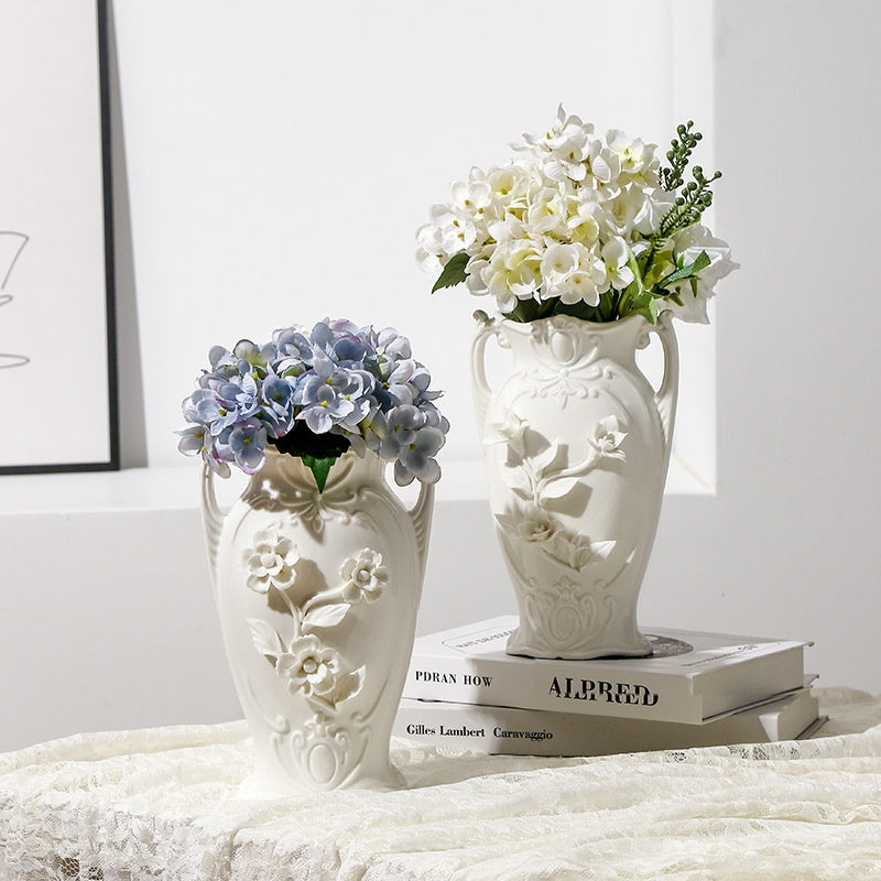 Vintage white ceramic Lily and Daisy vases with flowers on a soft lace tabletop