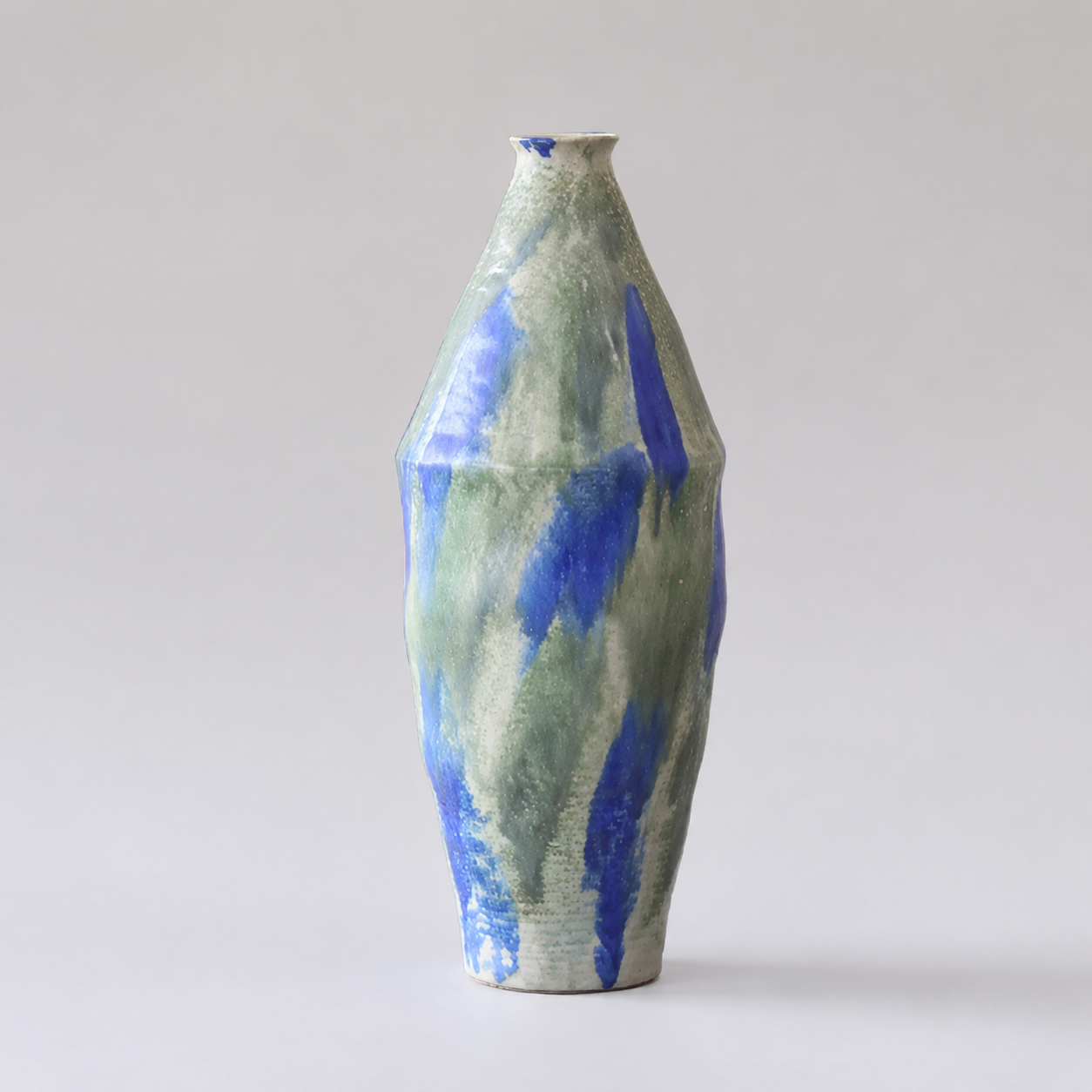 Slim wabi sabi inspired ceramic vase with abstract blue and green glaze 