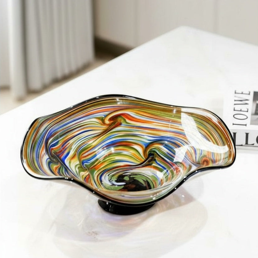 Multicolor wavy art glass centerpiece bowl displayed on a light tabletop