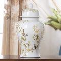 White ceramic ginger jar vase with floral bird design and lid on wooden console table