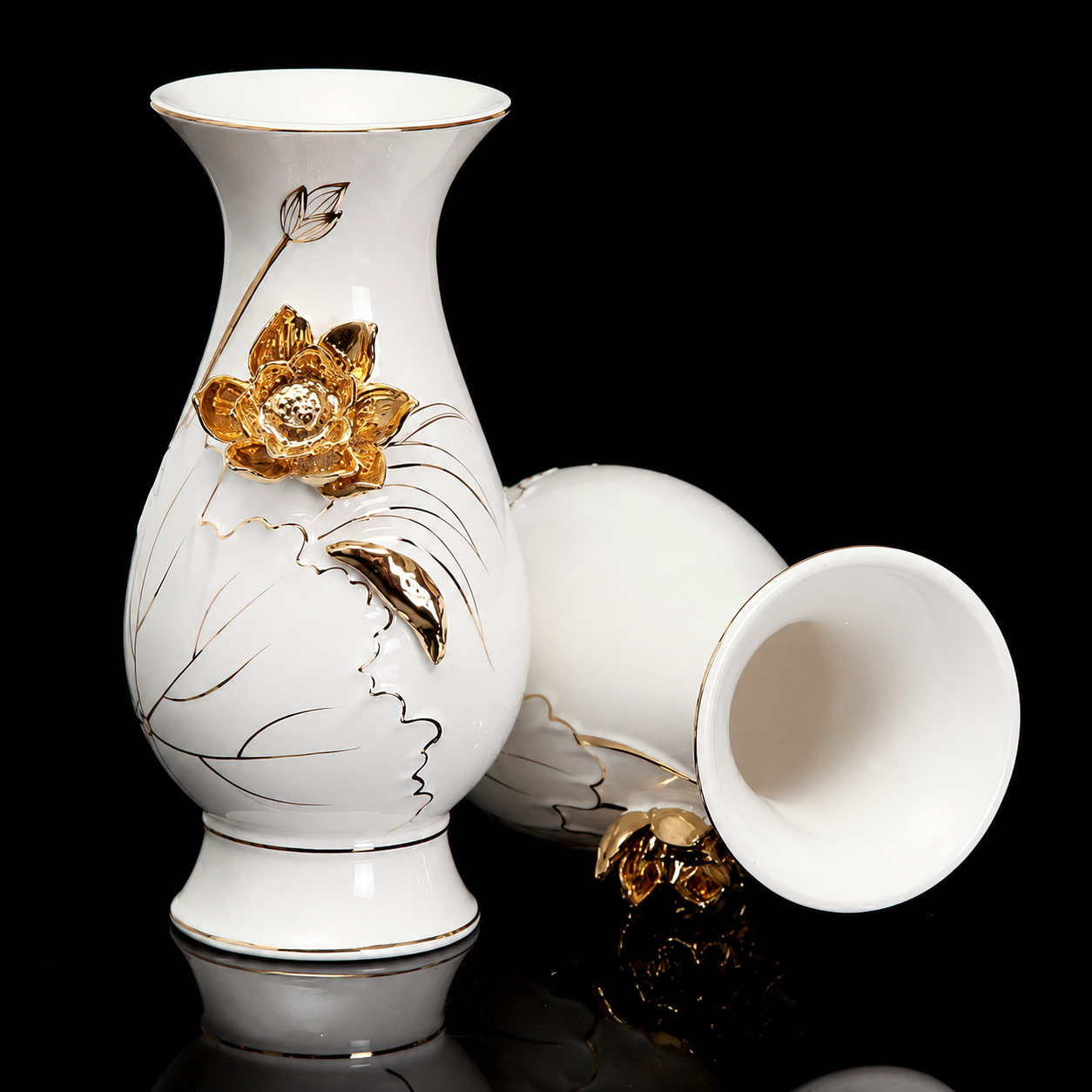 White ceramic vase with raised gold lotus flower and matching side view on black background