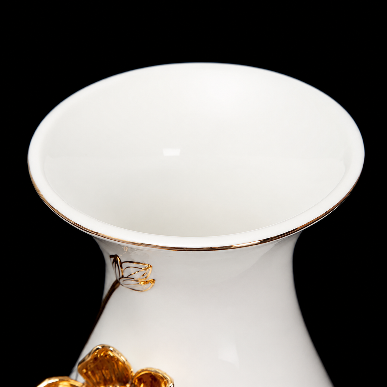 Close-up of white ceramic vase opening with thin gold rim