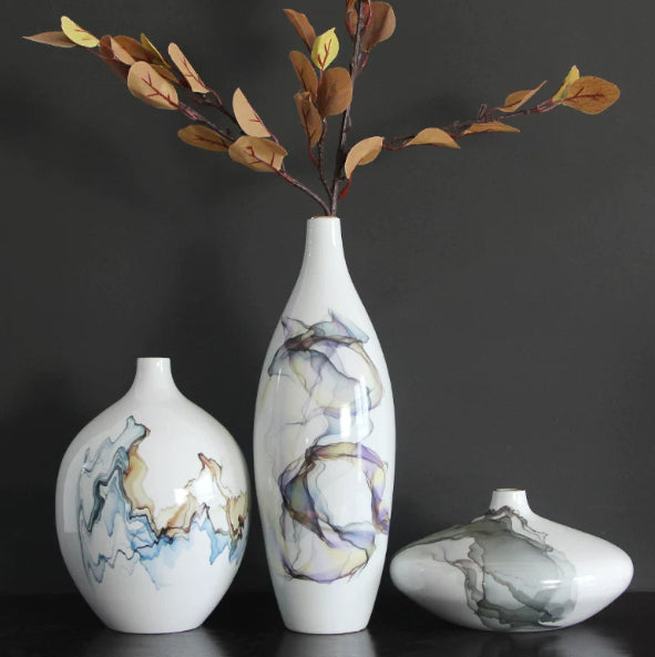 White ceramic vases with blue gray and brown abstract glaze on dark background