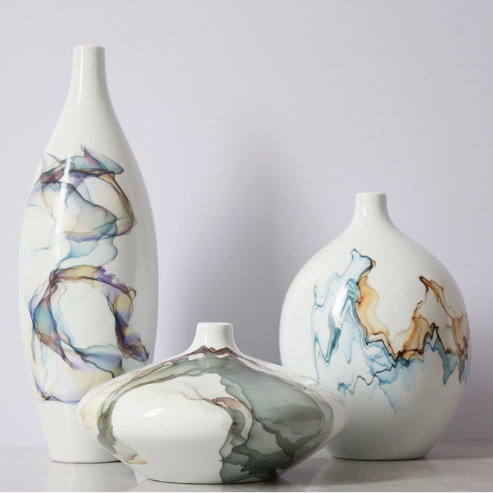 White ceramic vases with abstract glaze in tall round and low profile shapes