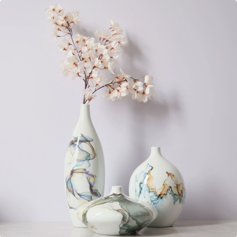 White ceramic vase set with abstract glaze and dried floral arrangement