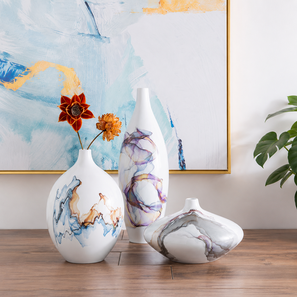 White ceramic vases with abstract glaze styled on wooden table with modern wall art