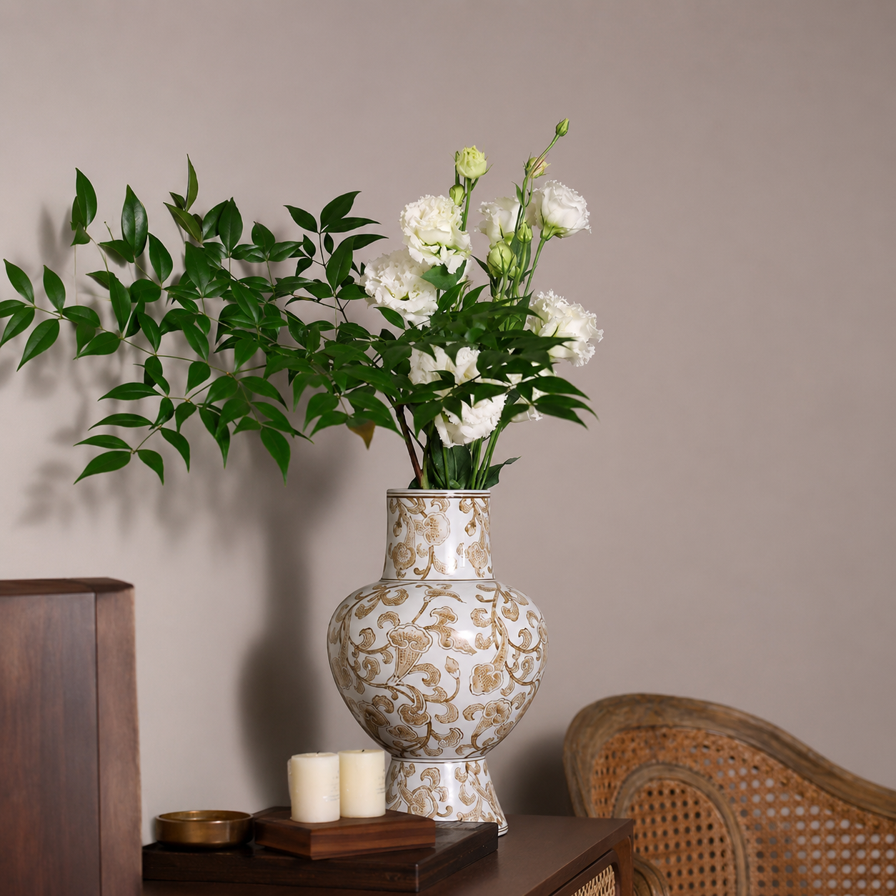 White and gold chinoiserie ceramic vase with flowers on a wooden side table in elegant home decor setting