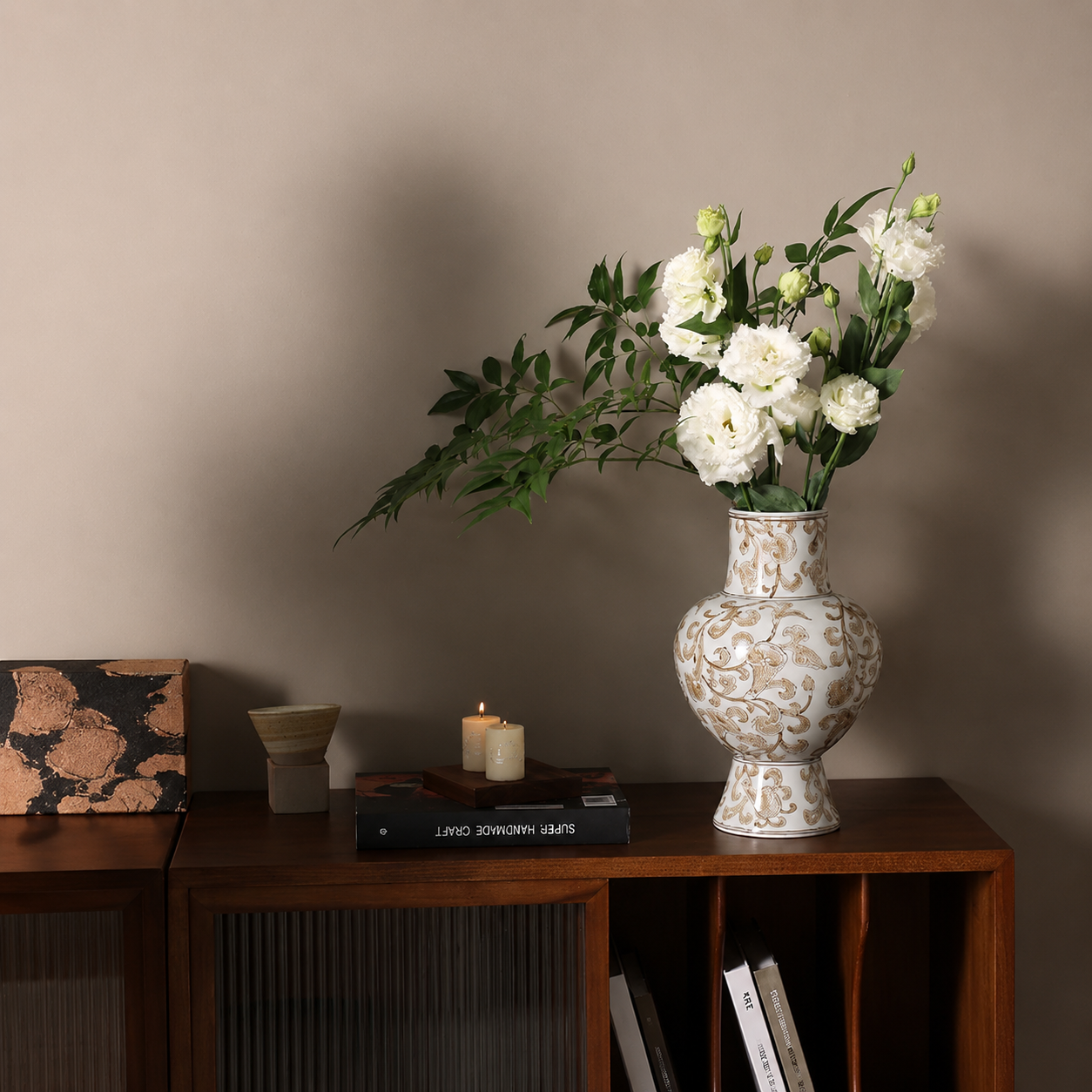 Chinoiserie ceramic vase with white flowers on a wooden sideboard for elegant dining room or console styling