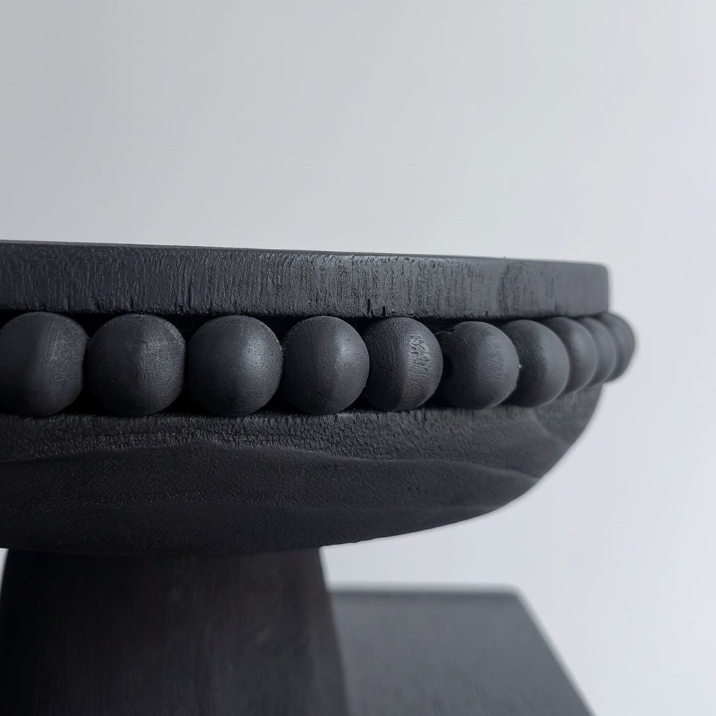 Close up of matte black wooden centerpiece bowl showing rounded beaded rim detail