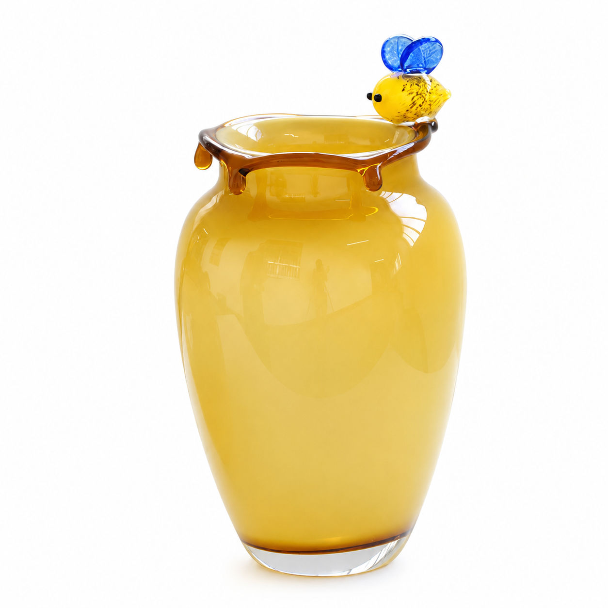 Tall yellow art glass vase with bee accent and amber honey drip rim on white background