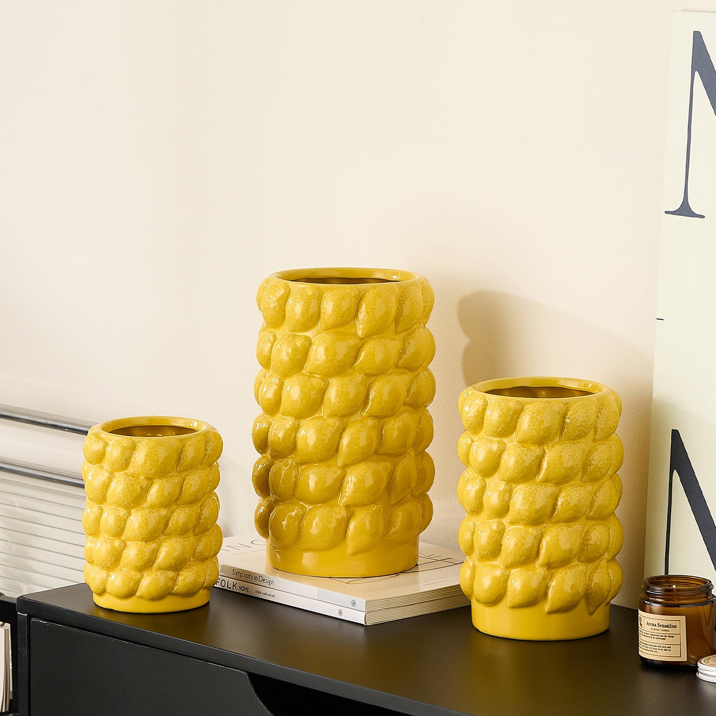Yellow ceramic lemon textured vases in three sizes displayed