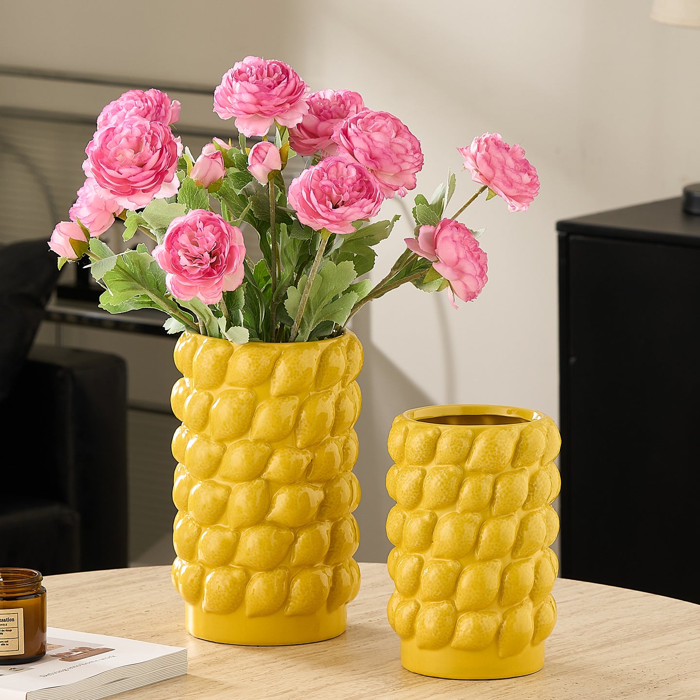 Yellow ceramic lemon textured vases with pink floral arrangements for modern interior styling
