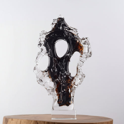 Detailed view of black and amber abstract glass sculpture
