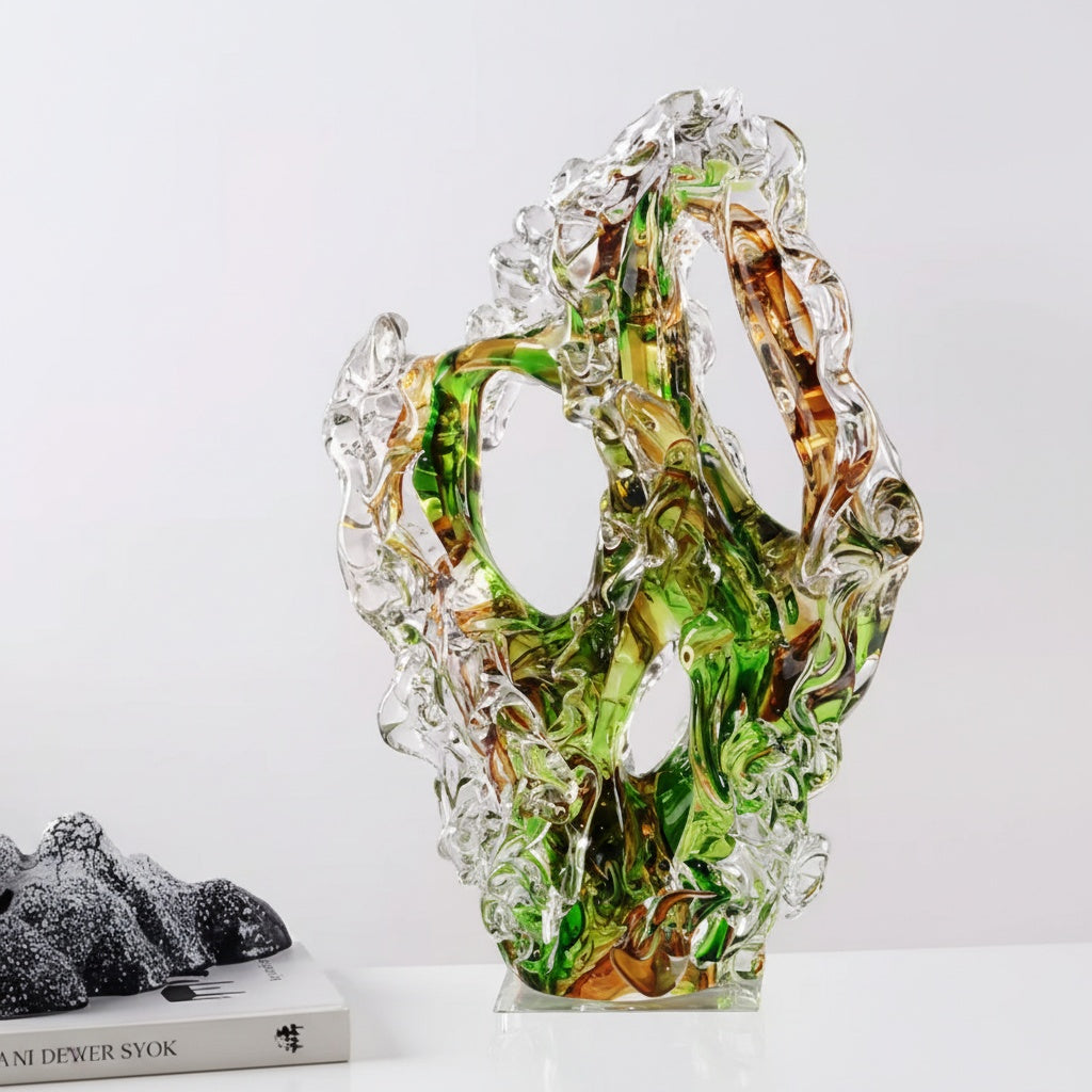 Detailed view of green and amber abstract glass sculpture