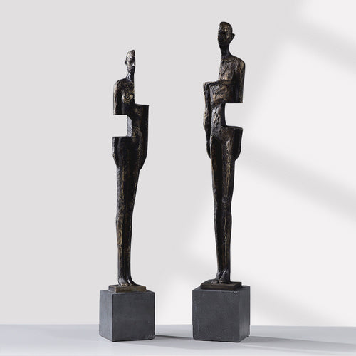 Antique bronze resin abstract figure sculptures in male and female designs on black bases