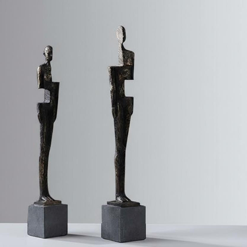 Perspective view of two abstract bronze finish sculptures