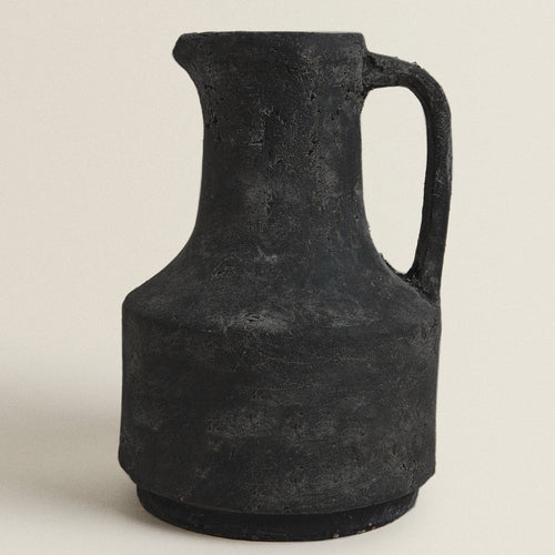 Front view of textured black stone decorative jug