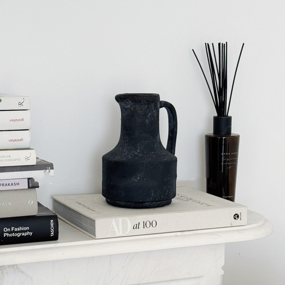 Black stone pitcher vase styled on books