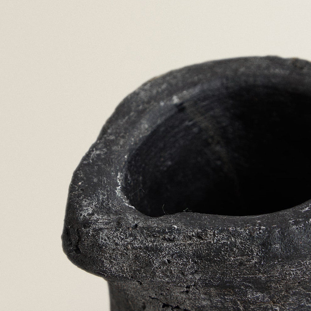 Close up detail of rough texture on stone vase rim