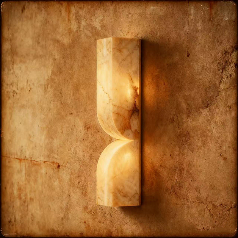 Artistic shot of alabaster sconce on textured rustic wall