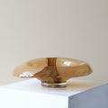 Side profile of amber art glass bowl with clear base