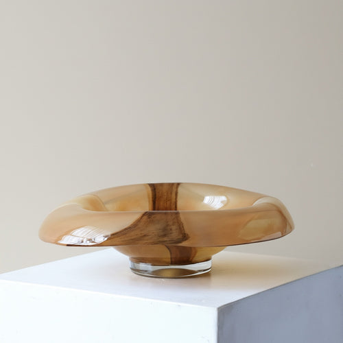 Side profile of amber art glass bowl with clear base