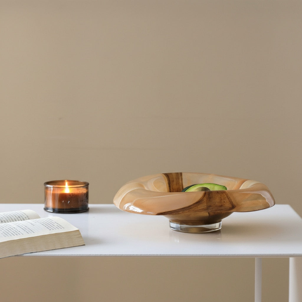 Lifestyle shot of glass bowl with avocado and candle