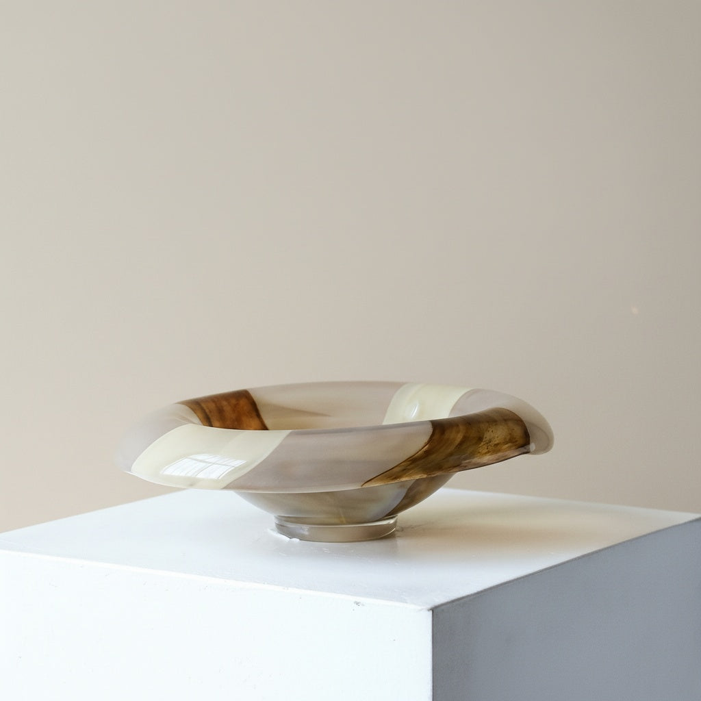 Side profile of milky white and amber glass bowl