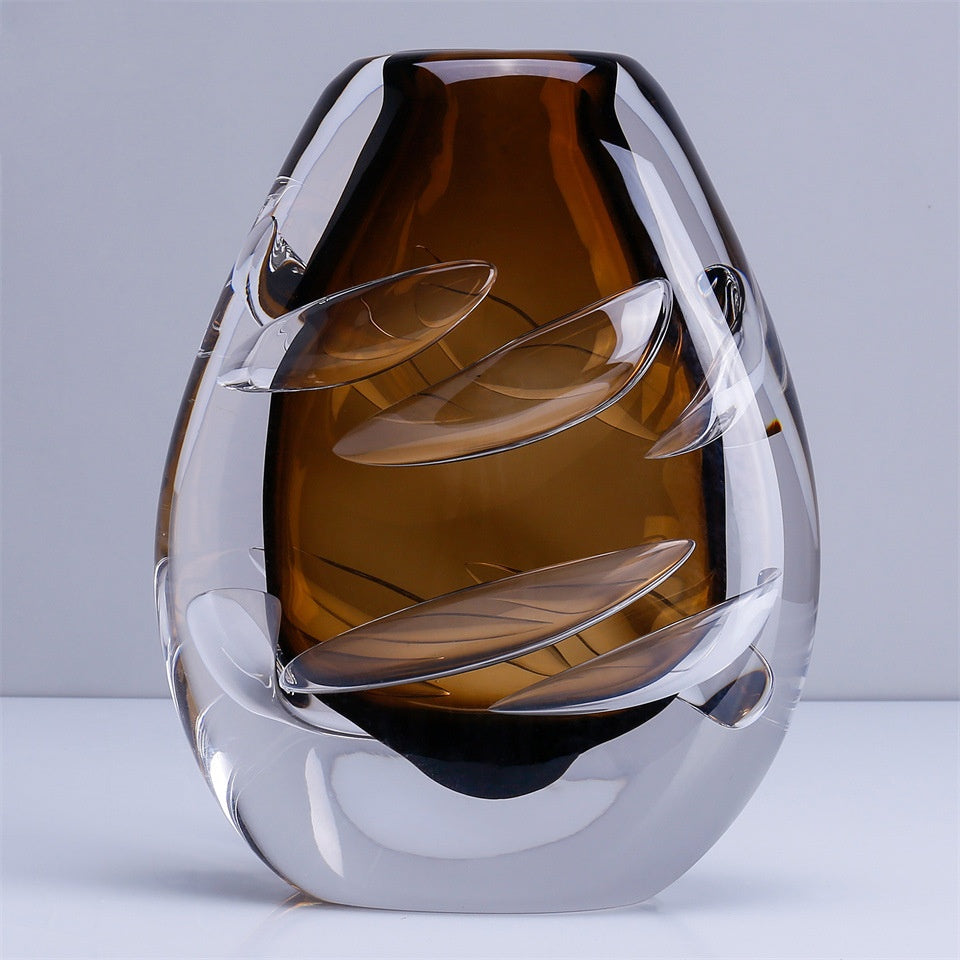 Front view of amber glass vase showing leaf pattern cuts