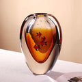 Front view of amber art glass vase with fish motif