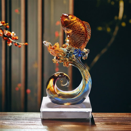 Side view of art glass leaping koi sculpture with blue wave detail